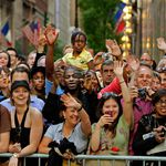 New Yorkers wave at the Obamas' motorcade